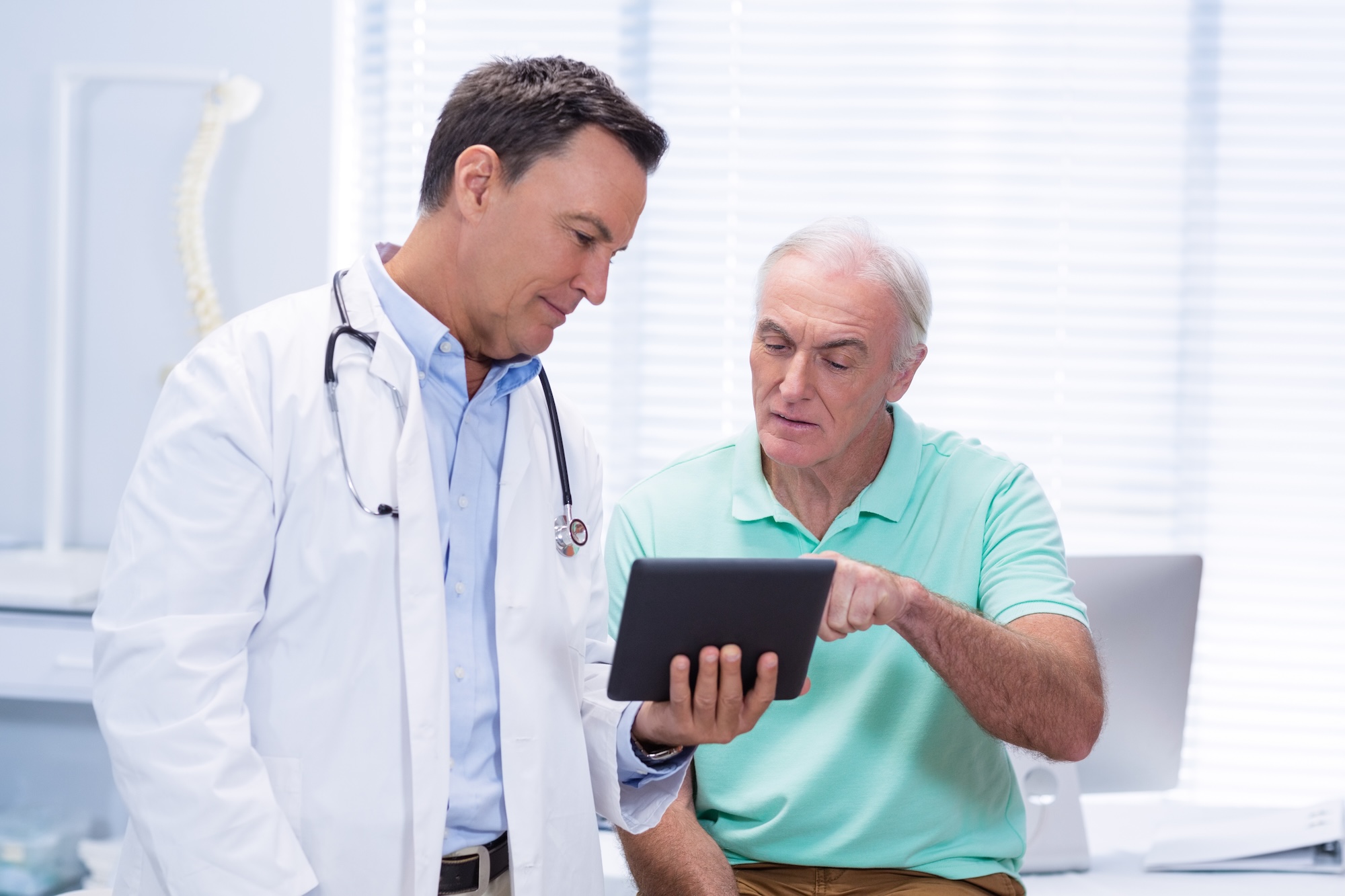 Older male patient at Crescent Beach Care talking to a doctor about his options for non-surgical weight loss in St. Augustine.