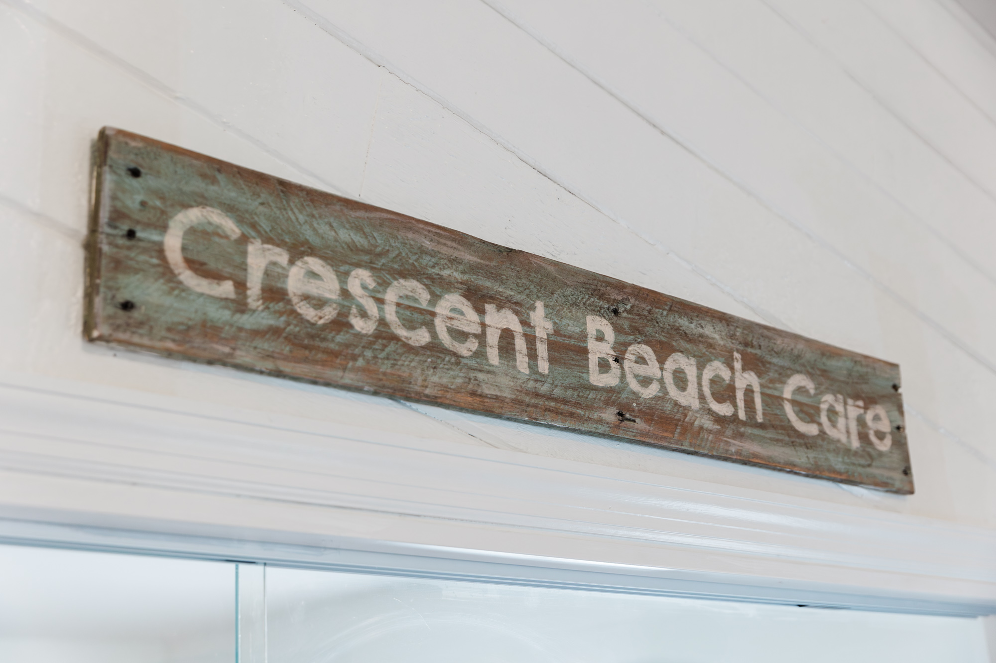 An image of the sign above the reception desk at Crescent Beach Care, the ideal clinic for skin tightening in St. Augustine.